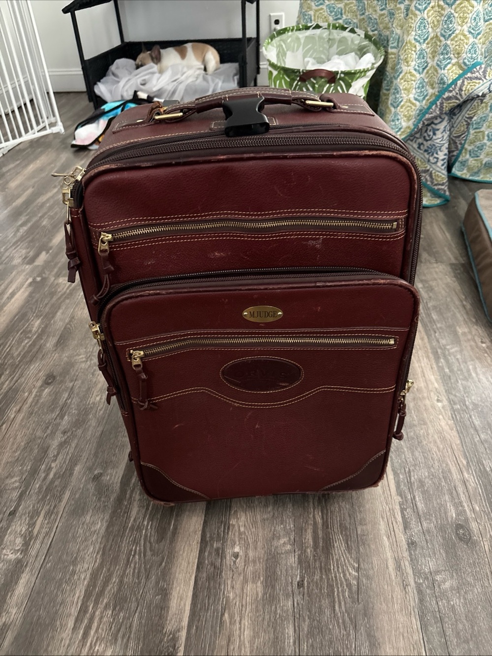 Orvis 
 Burgundy Travel Suitcase with Gold Accents and two wheels